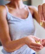 Woman-Holds-Pills-2161393860-Blog-MainArticleImage